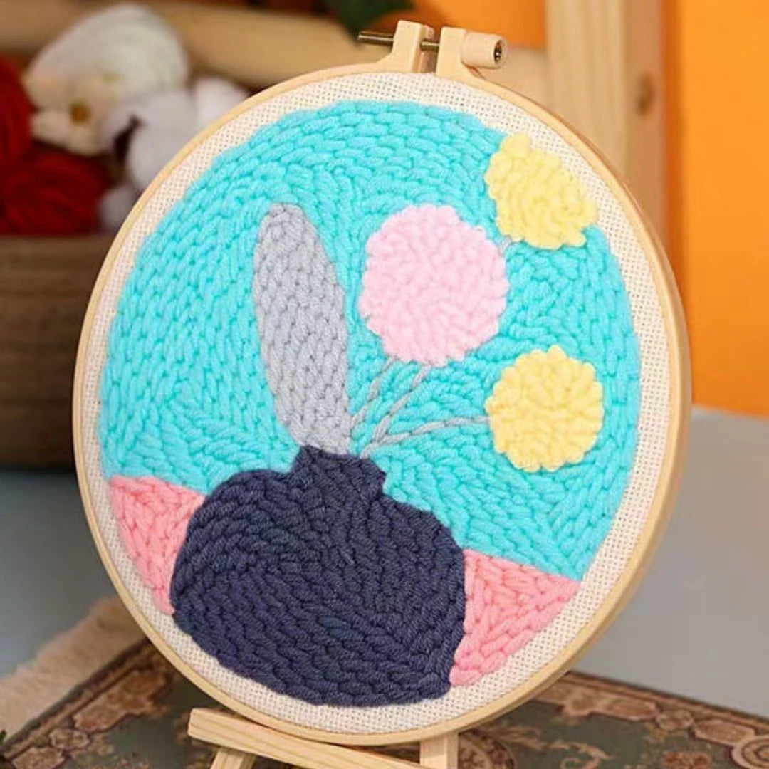 Punch Naald Bloemen op een blauwe en roze achtergrond